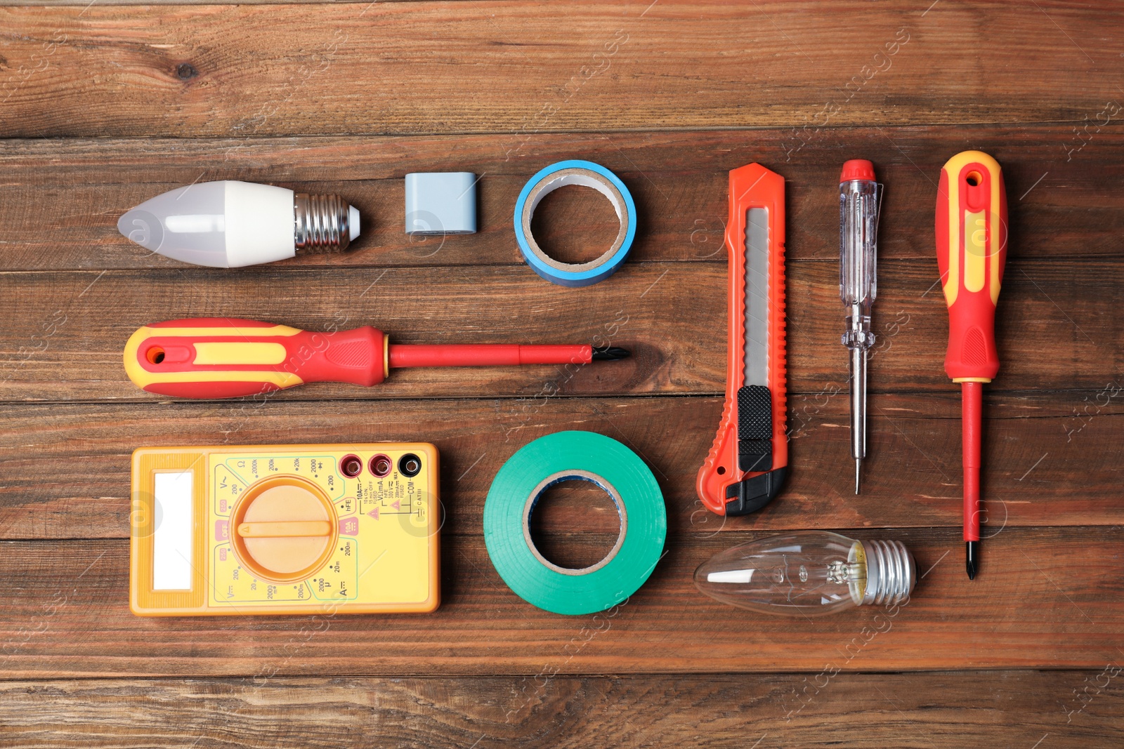 Photo of Flat lay composition with electrician's tools on wooden background