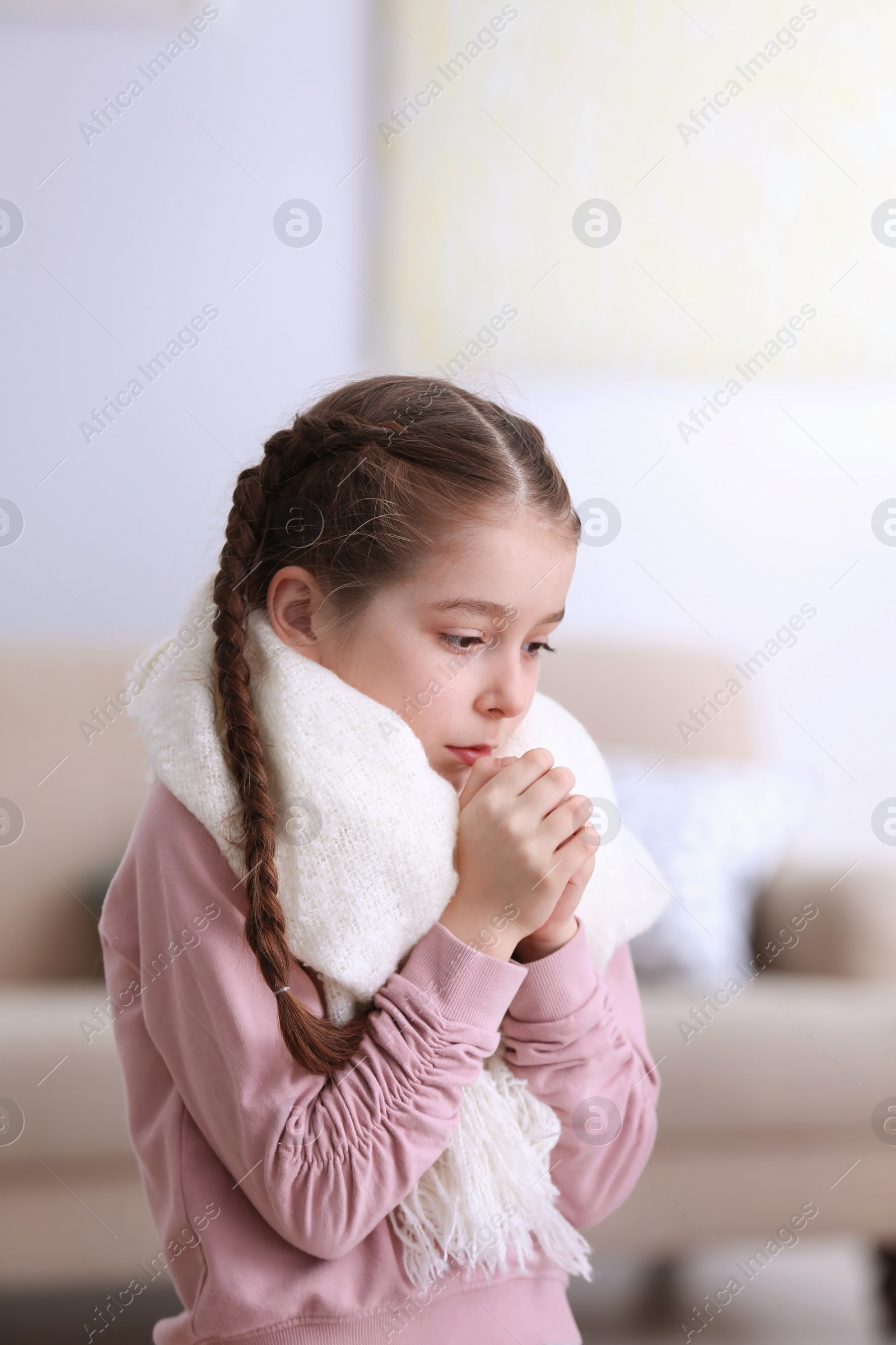 Photo of Sad little girl suffering from cold on blurred background