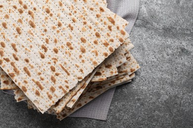 Photo of Stack of traditional matzos on grey table, above view