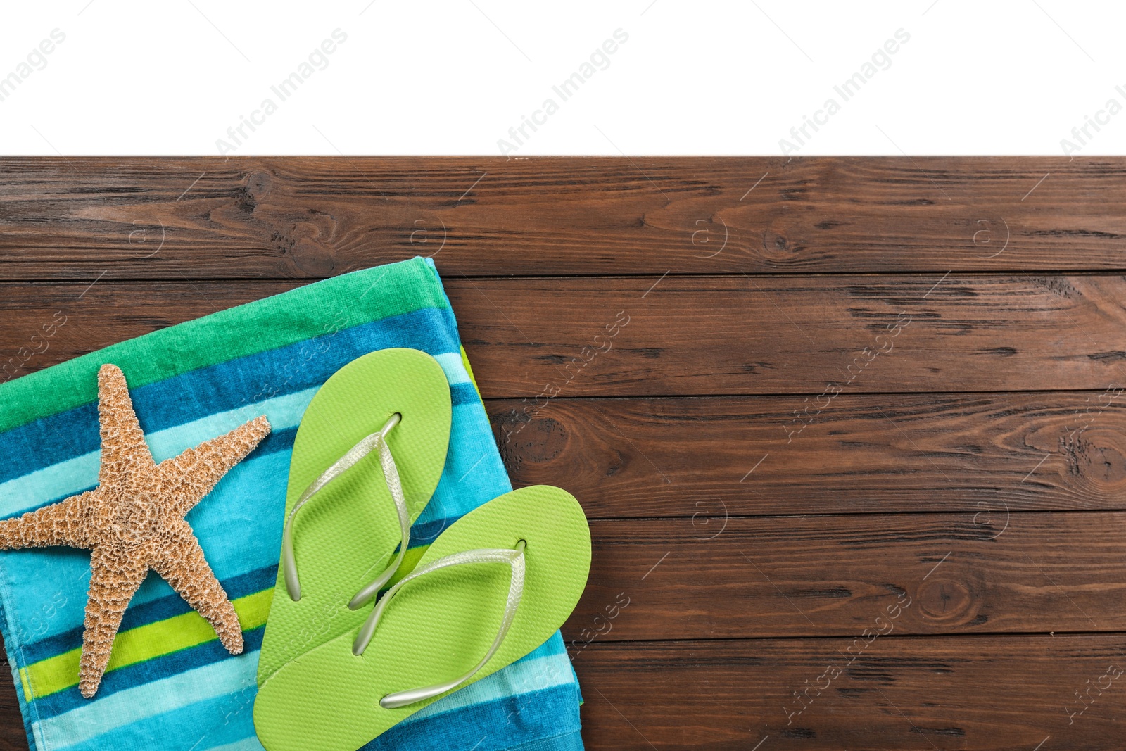 Photo of Flat lay composition with beach accessories on wooden background. Space for text