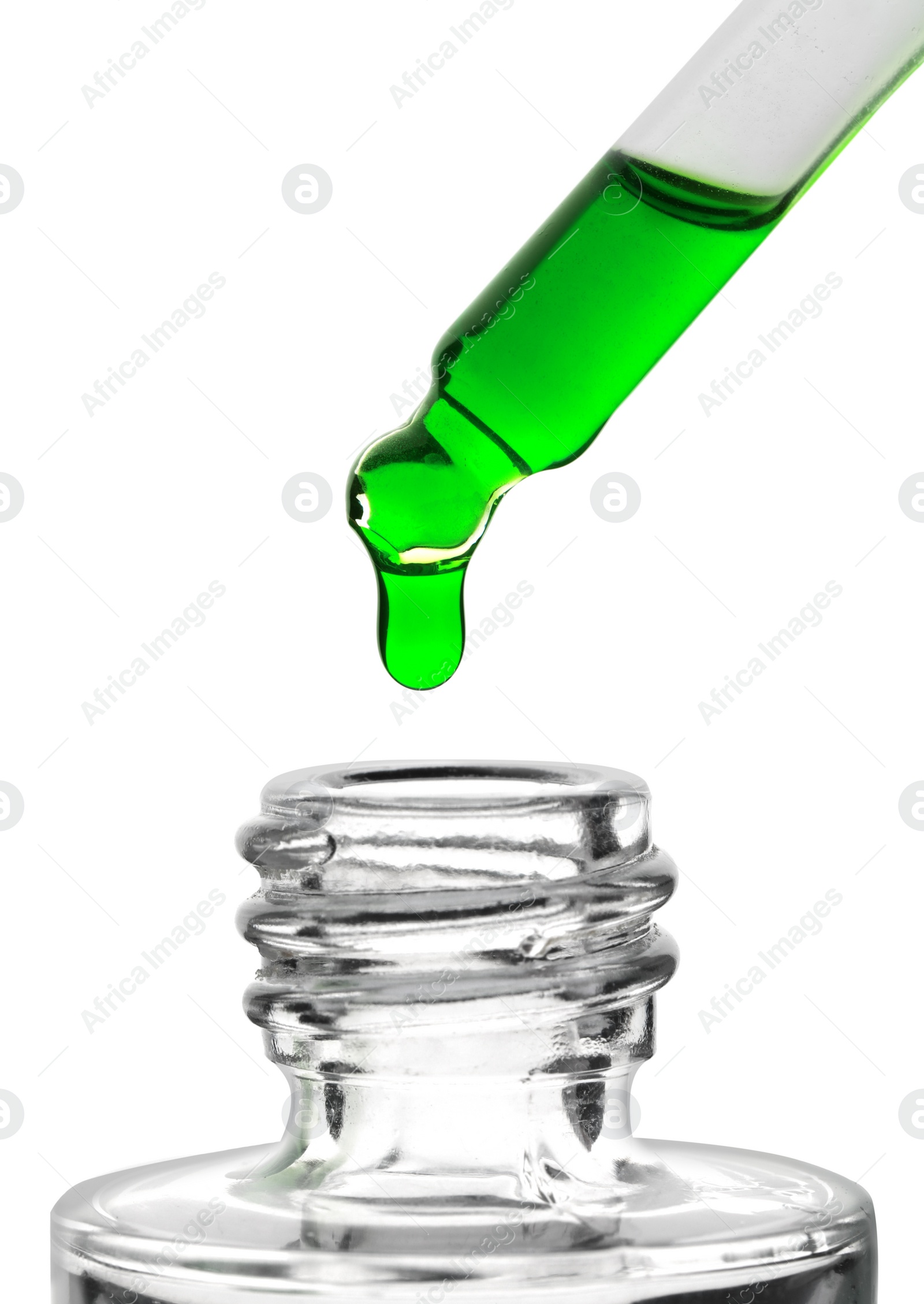 Photo of Dripping green facial serum from pipette into glass bottle on white background, closeup