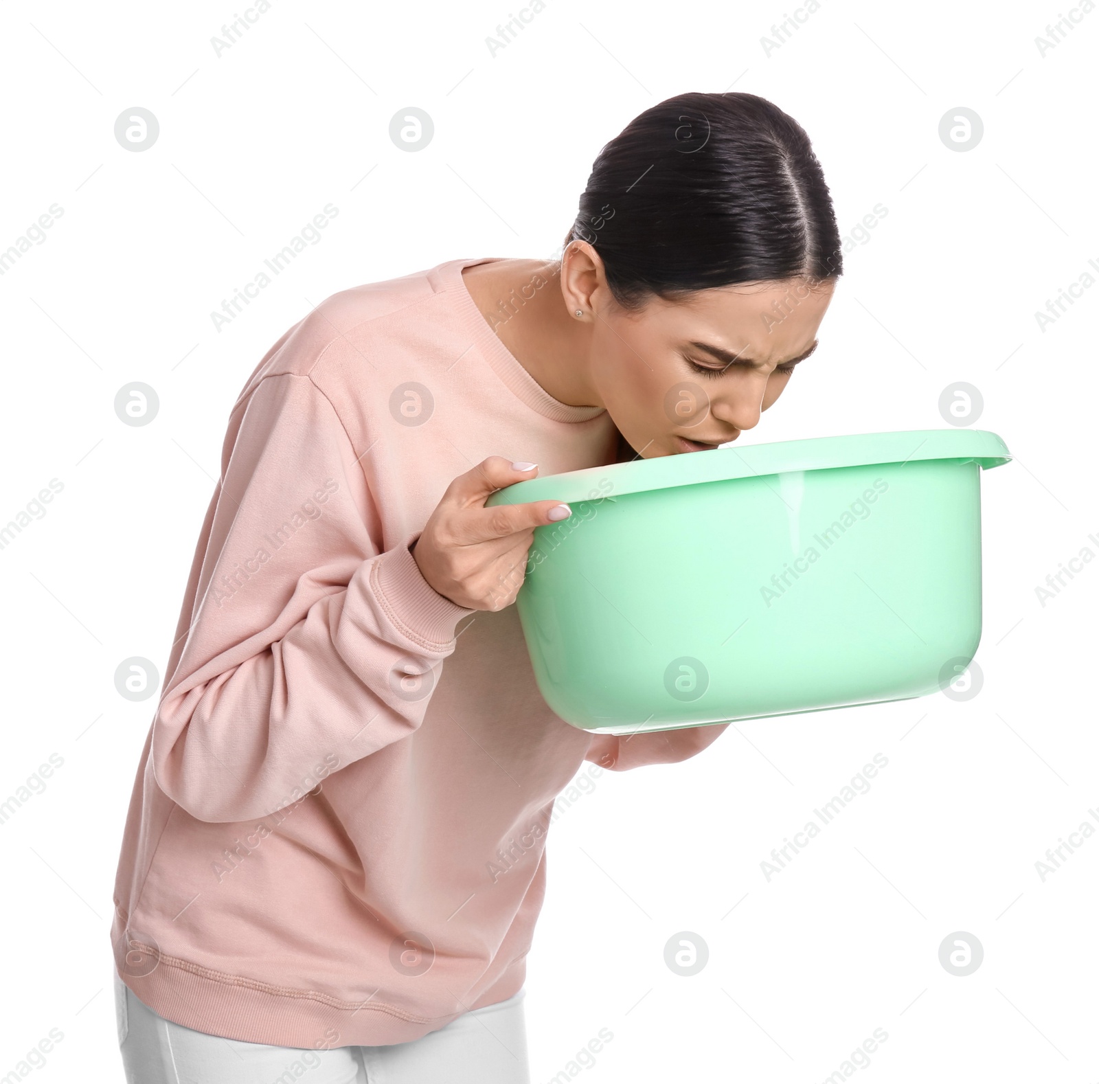 Photo of Woman with basin suffering from nausea on white background. Food poisoning