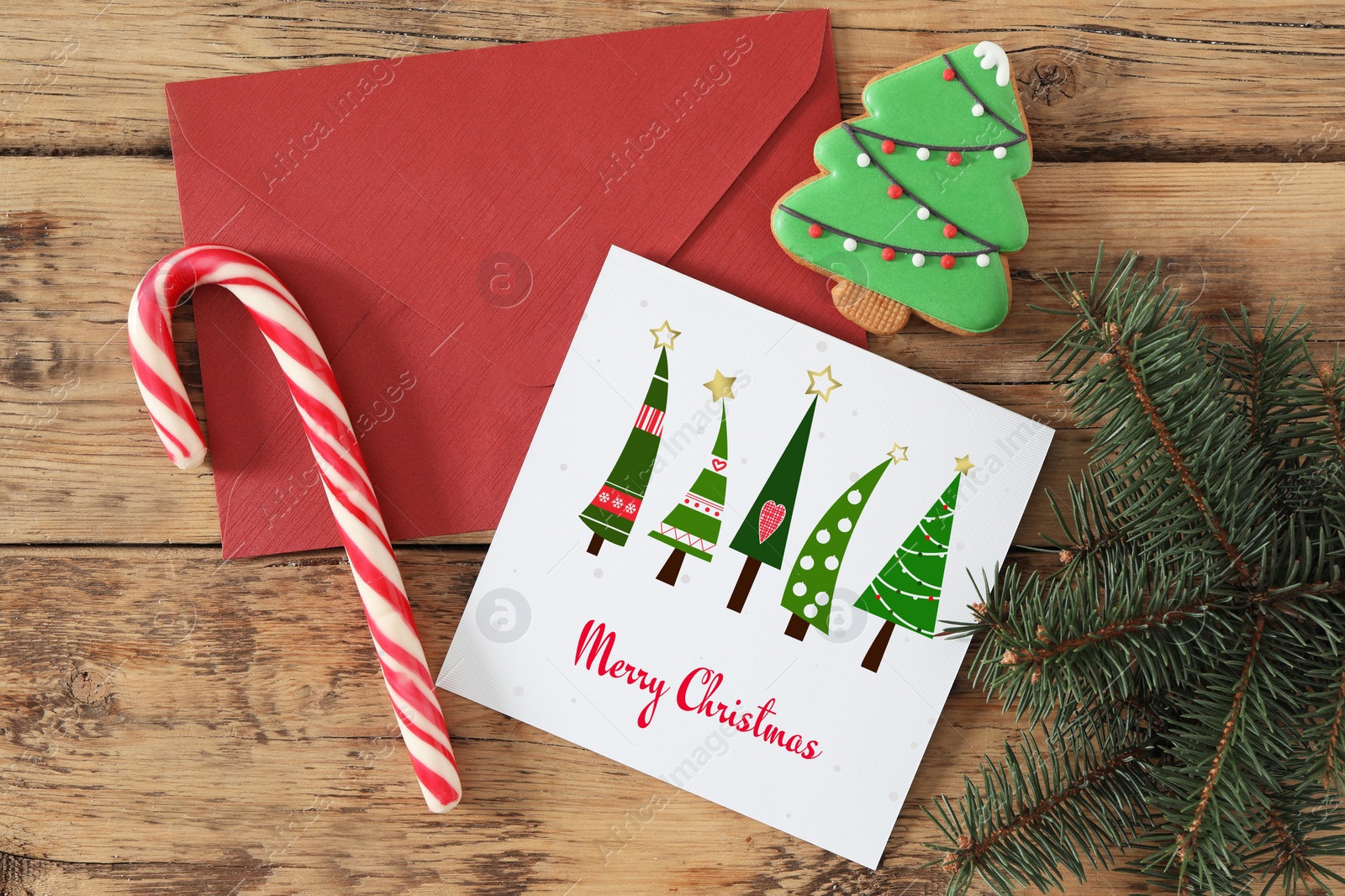 Image of Greeting card with text Merry Christmas on wooden table, flat lay