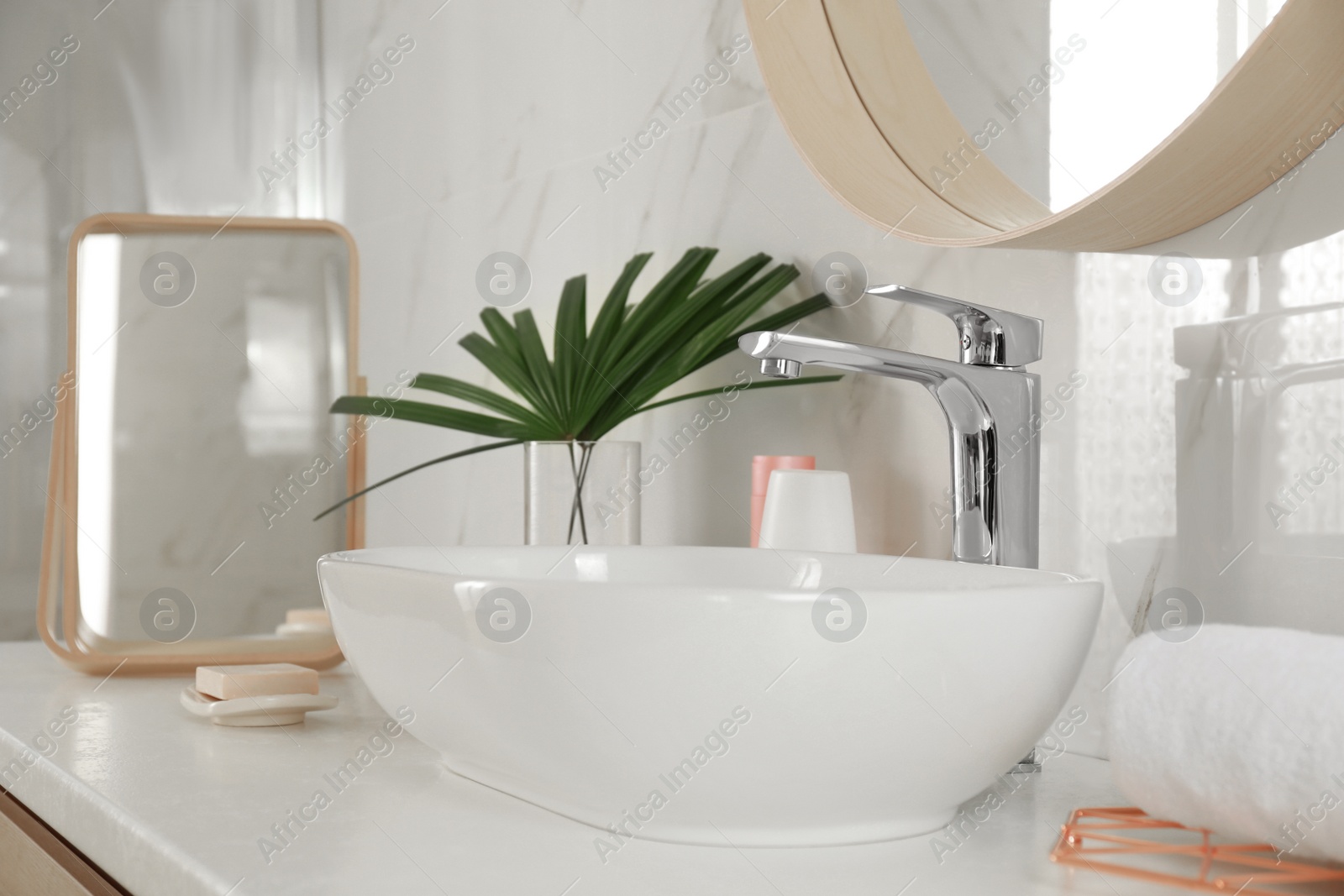 Photo of Stylish bathroom interior with vessel sink and decor elements