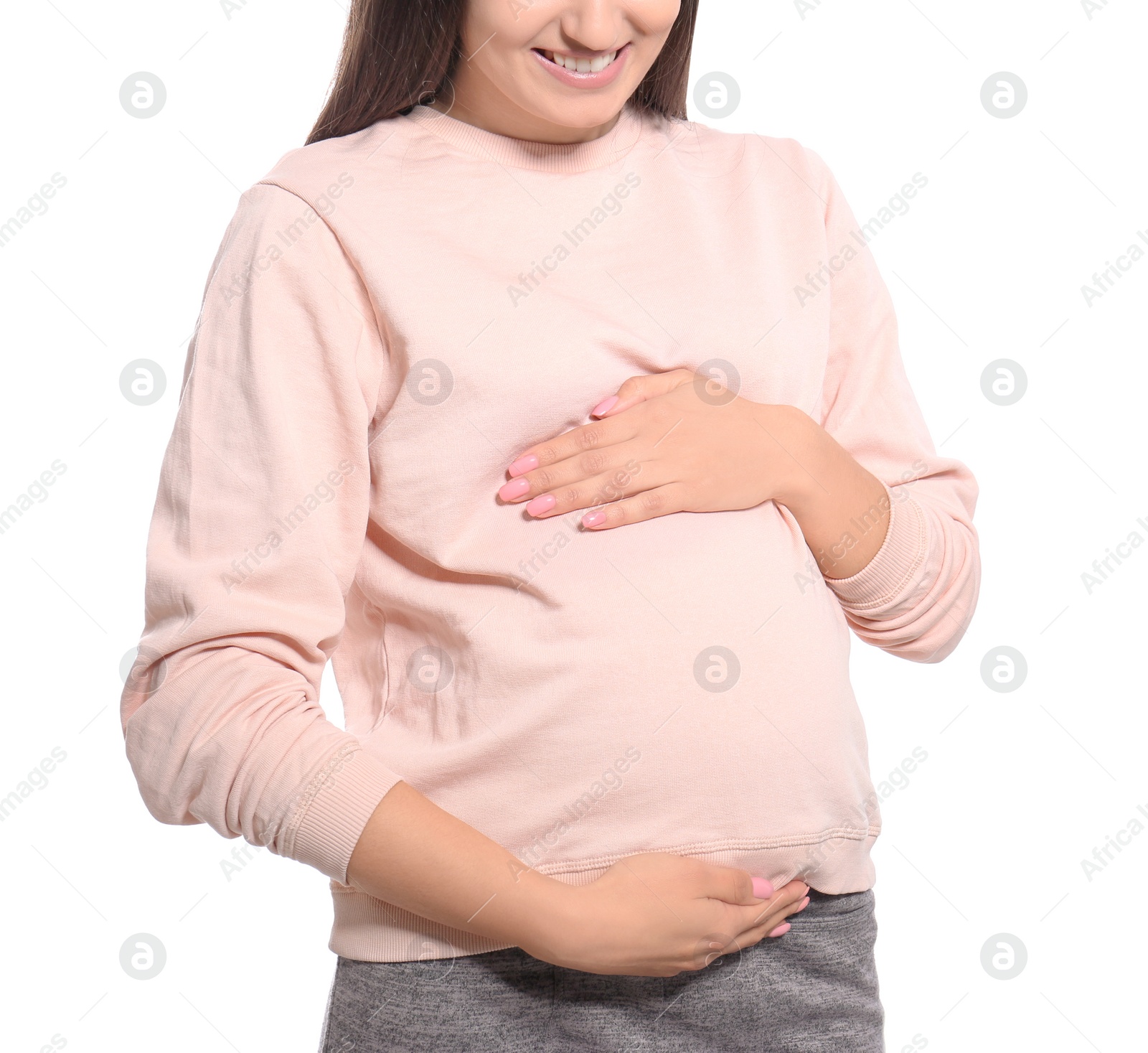 Photo of Young pregnant woman in casual clothes on white background