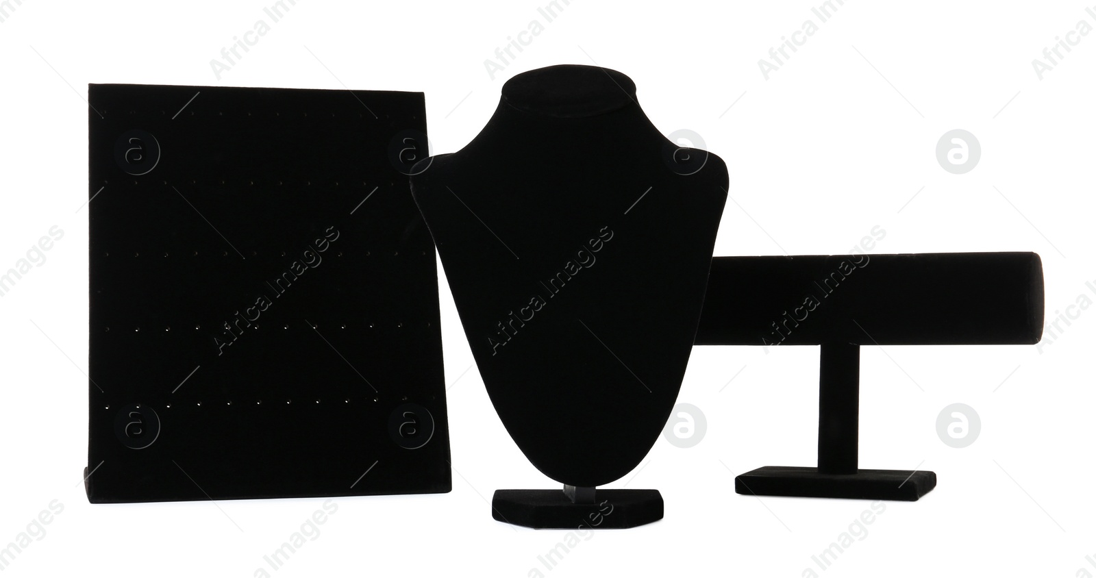 Photo of Different empty black velvet jewelry stands on white background