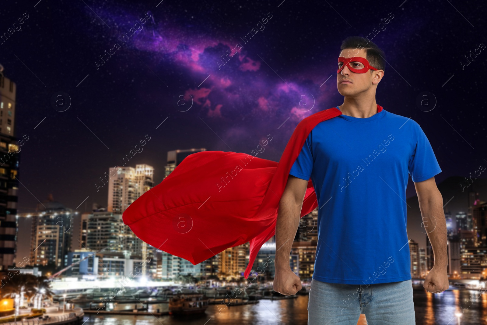 Image of Man wearing superhero costume and beautiful cityscape in night on background