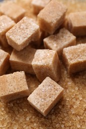 Photo of Different types of brown sugar as background, closeup