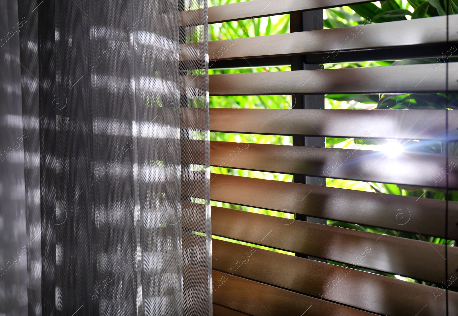 Photo of Window with beautiful curtain and blinds, closeup