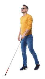 Blind man in dark glasses with walking cane on white background