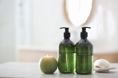 Photo of Green soap dispensers on white countertop in bathroom. Space for text