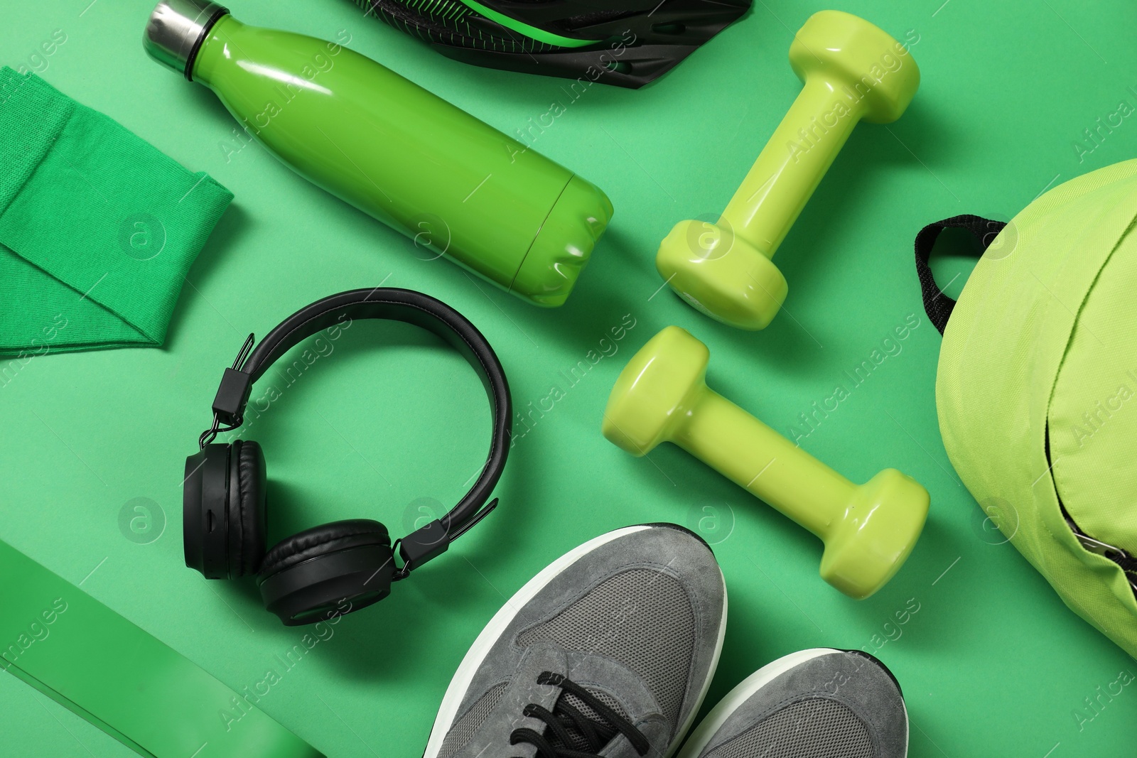 Photo of Different sports equipment on green background, flat lay