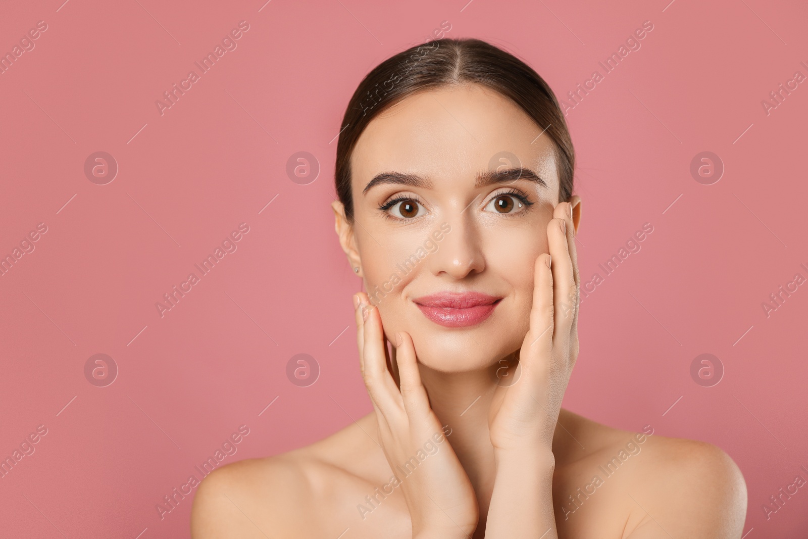 Photo of Beautiful woman with perfect smooth skin on pink background
