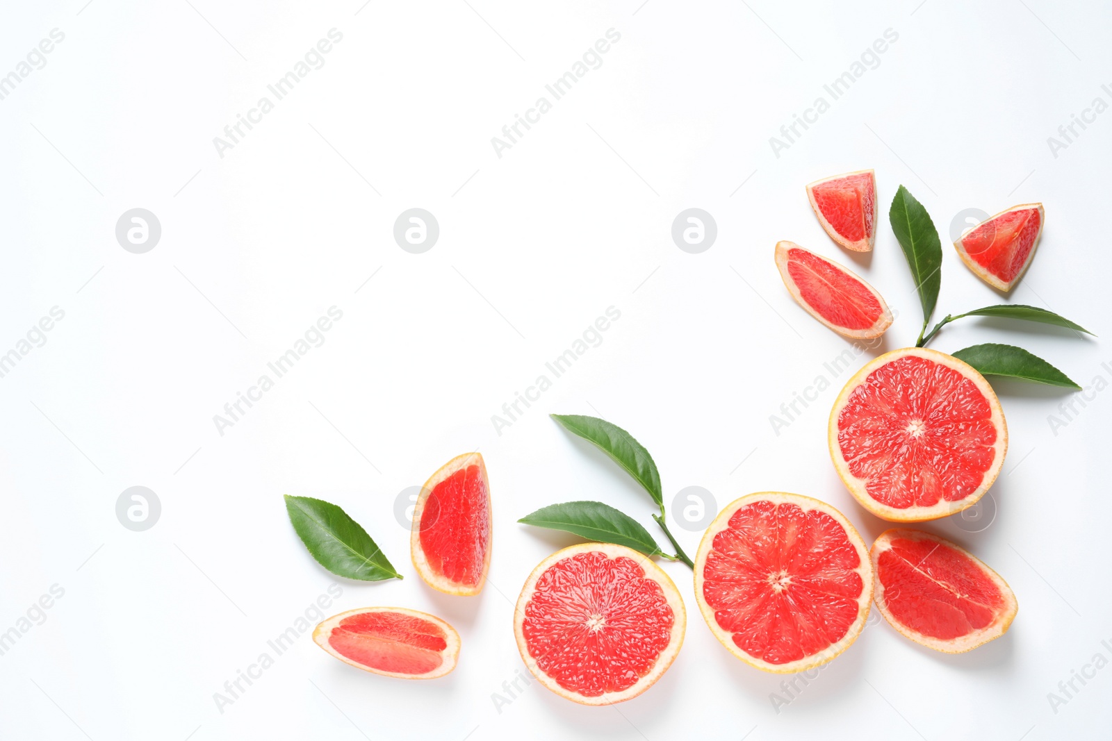 Photo of Frame made of grapefruits and leaves on white background, top view with space for text. Citrus fruits