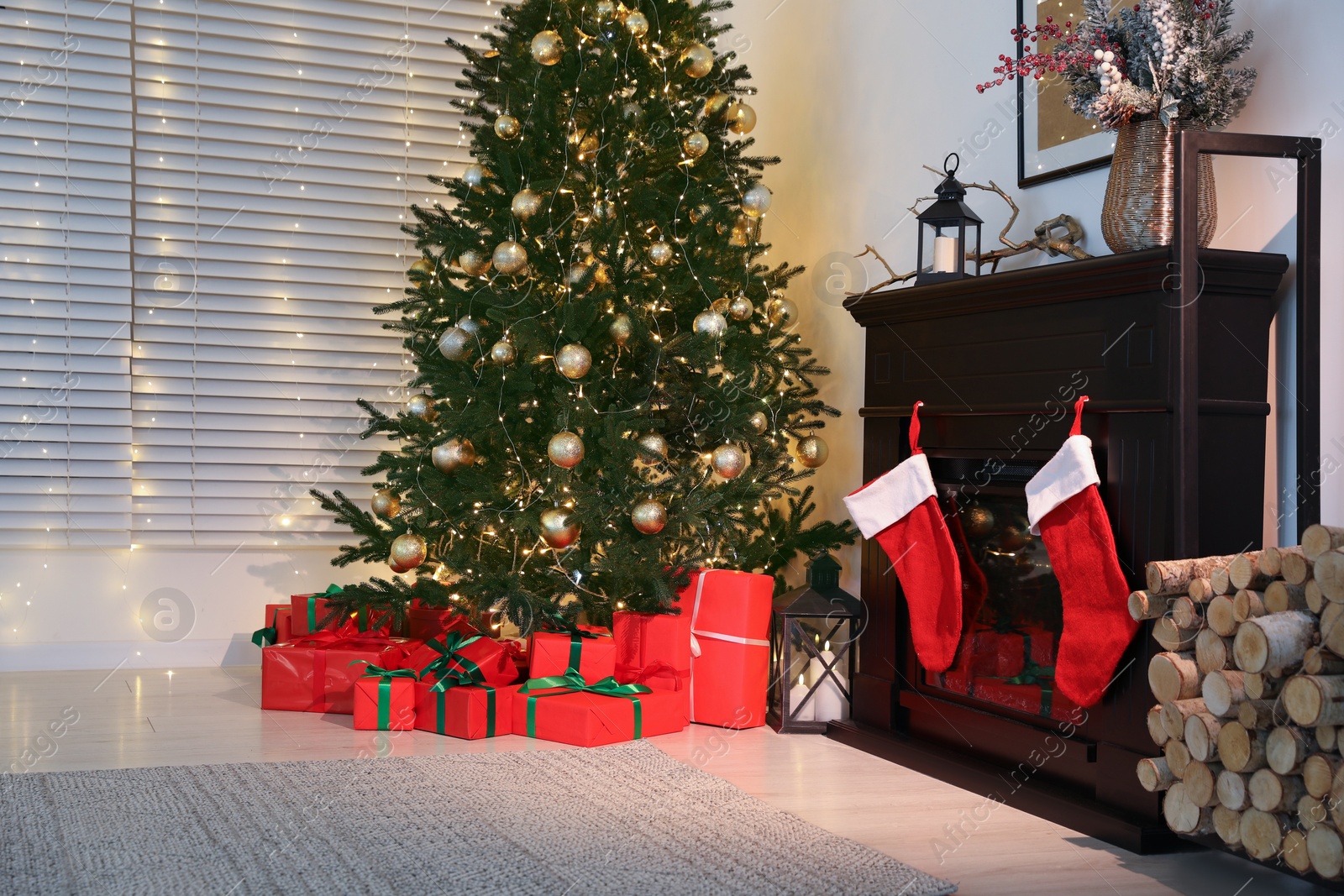 Photo of Beautifully wrapped gift boxes under Christmas tree in living room