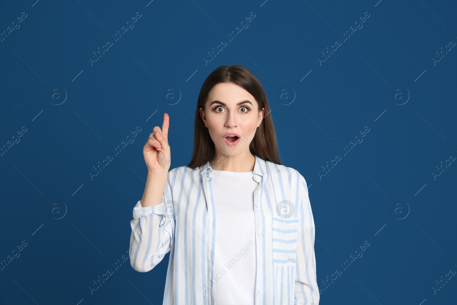 Photo of Portrait of emotional young woman on blue background