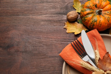 Festive table setting on wooden background, above view with space for text. Thanksgiving Day celebration