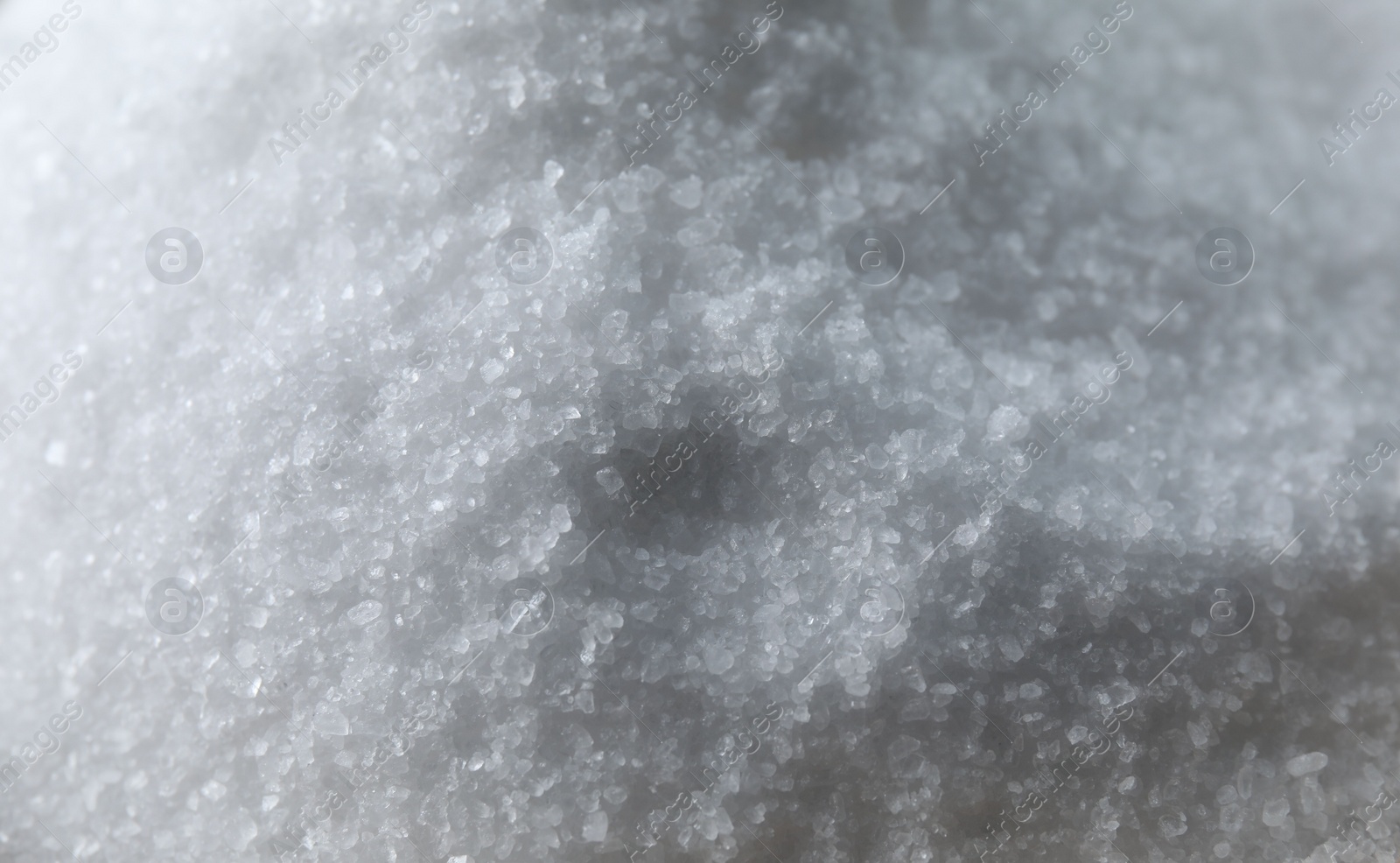 Photo of Organic white sea salt as background, closeup