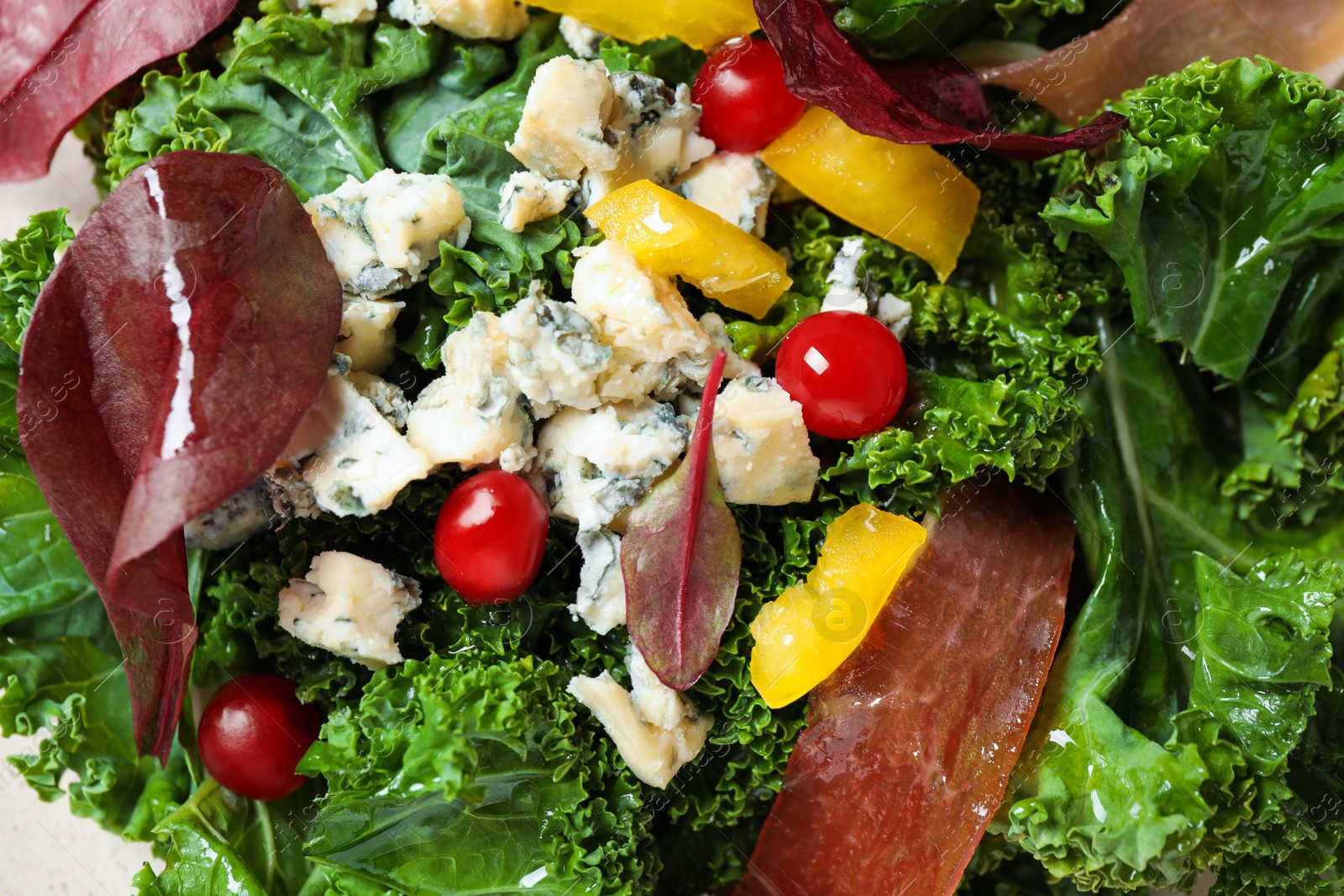 Photo of Tasty fresh kale salad as background, closeup