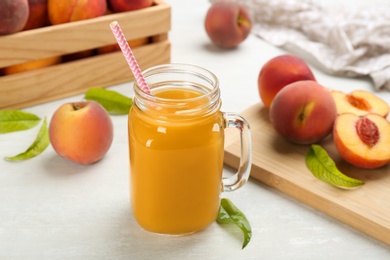 Photo of Natural freshly made peach juice on white table