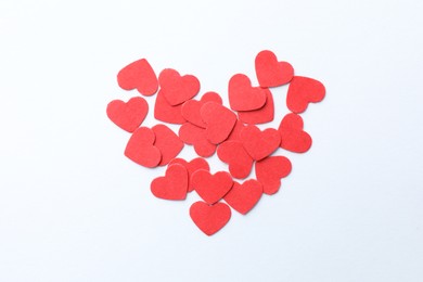 Paper hearts on white background, top view