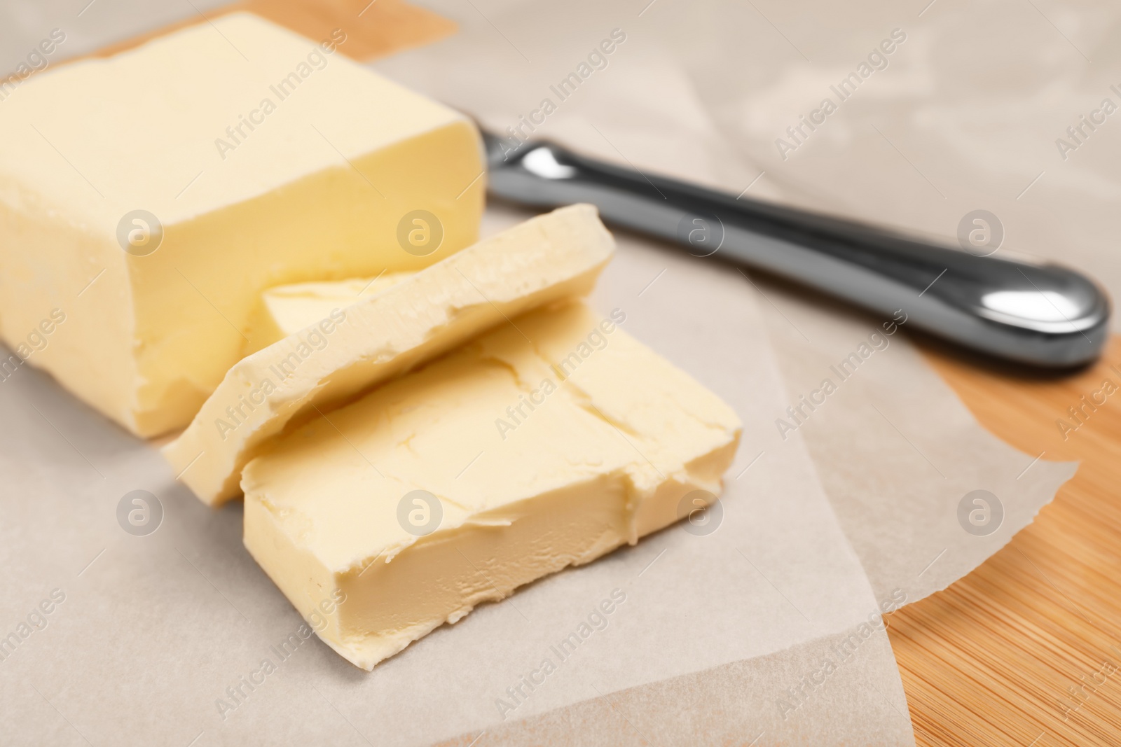 Photo of Wooden board with tasty fresh butter, closeup