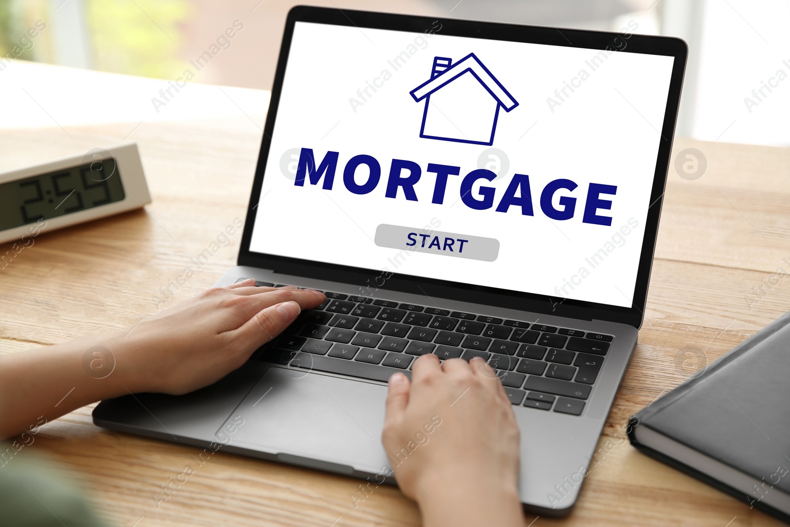 Image of Mortgage concept. Woman using modern laptop at table, closeup