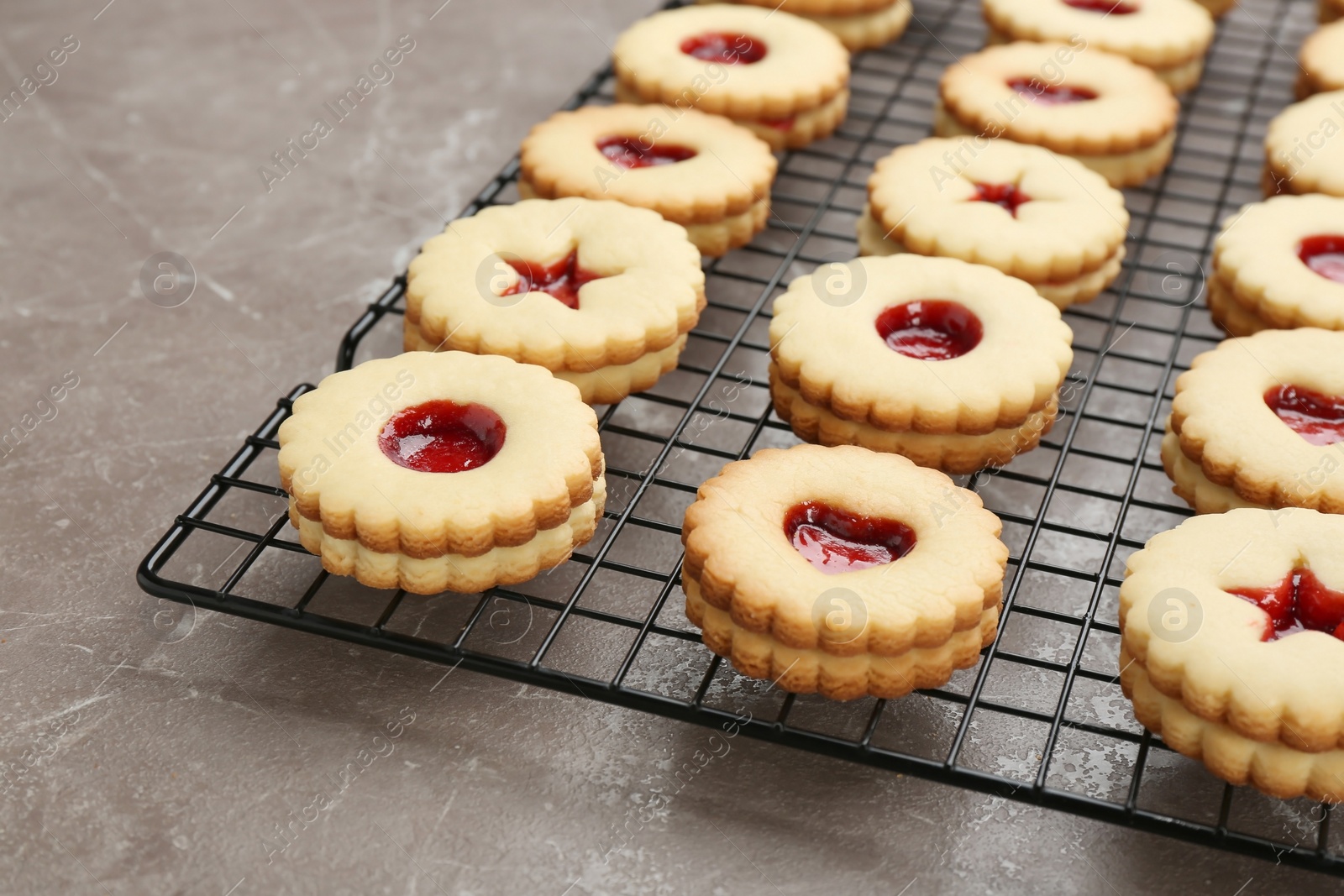 Photo of Traditional Christmas Linzer cookies with sweet jam on cooling rack