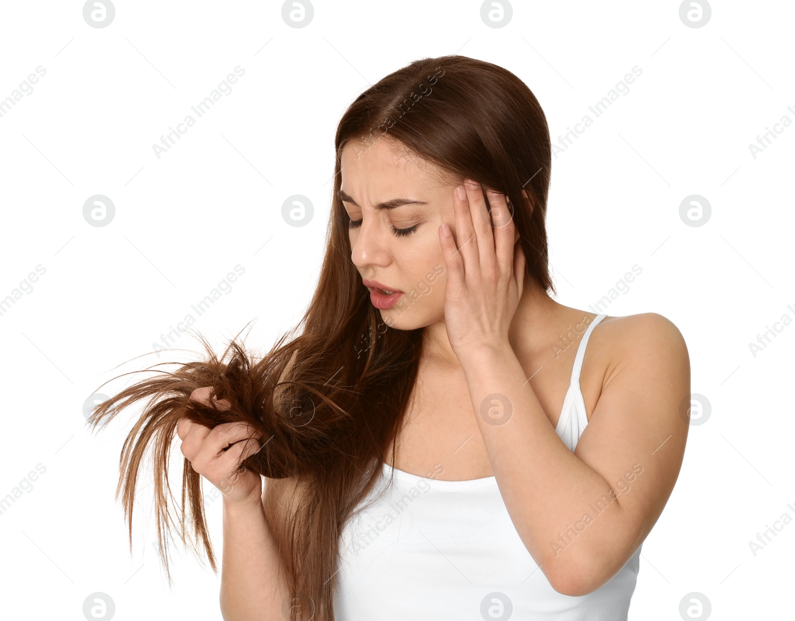 Photo of Emotional woman with damaged hair on white background. Split ends