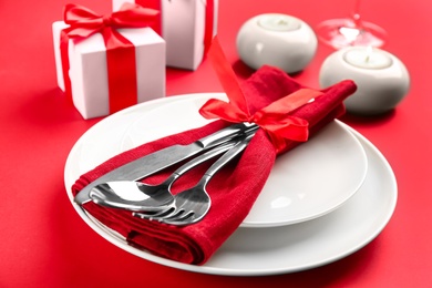 Beautiful table setting for Valentine's Day on red background