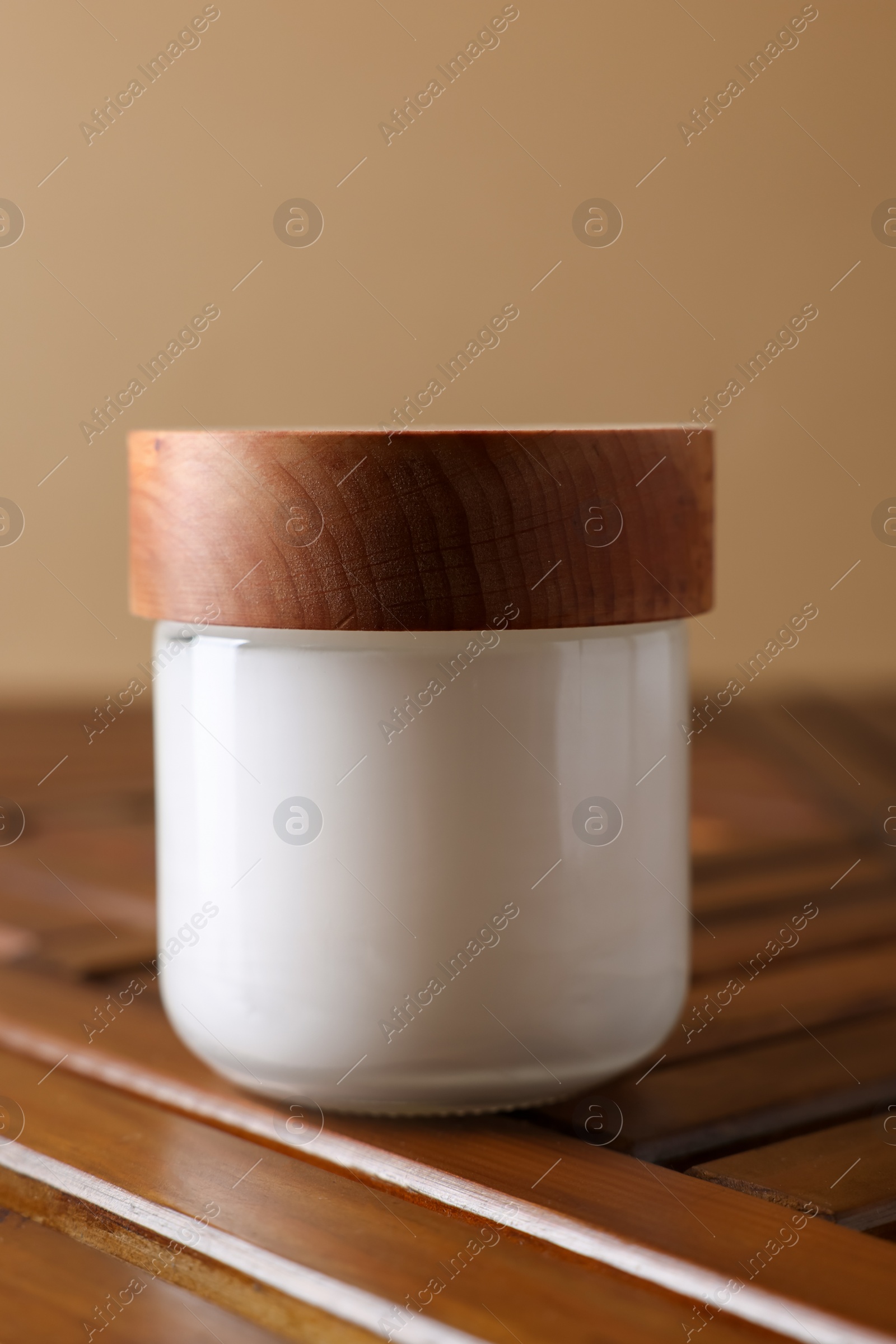 Photo of Jar of luxury cream on wooden table, closeup