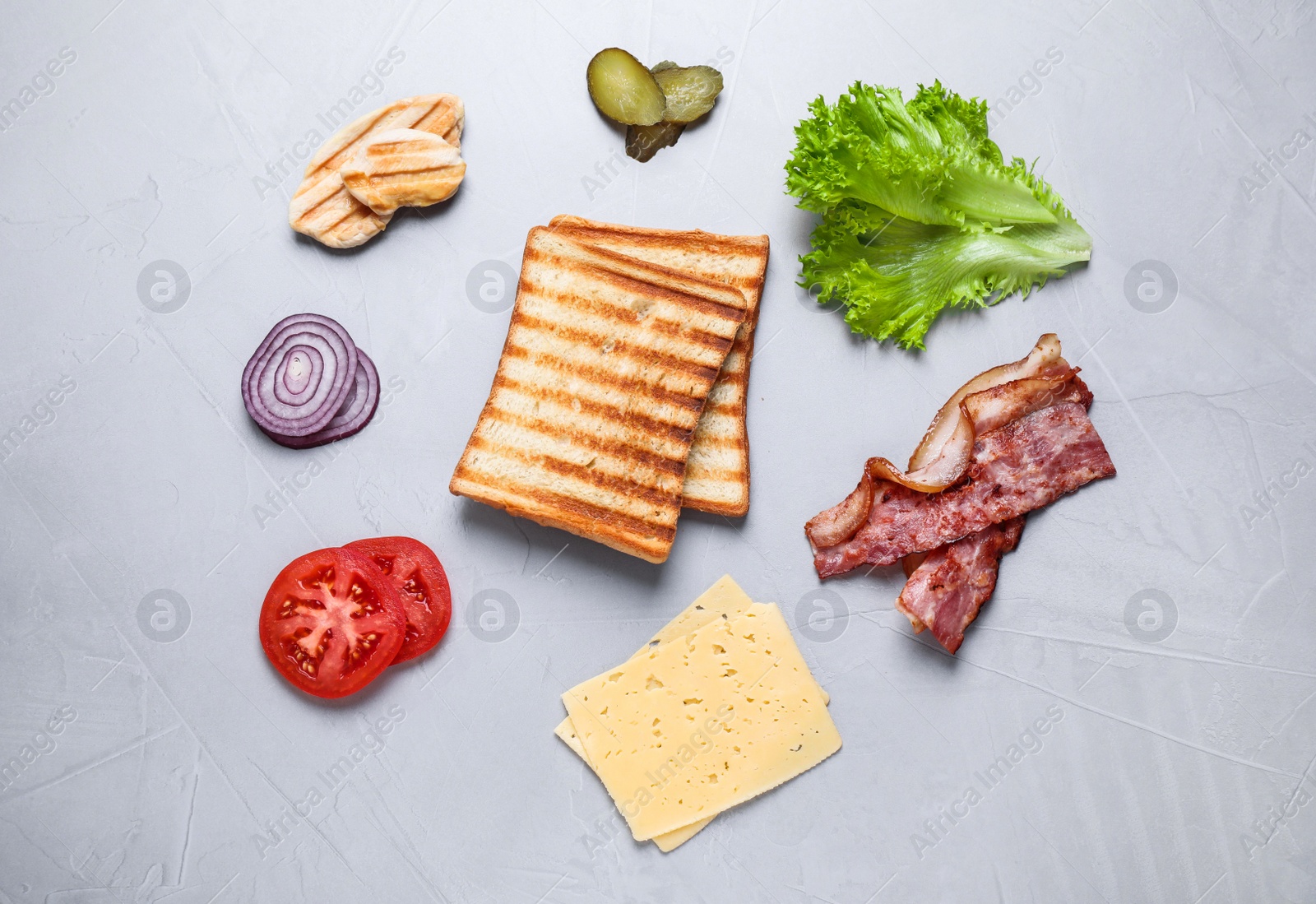 Photo of Fresh ingredients for tasty sandwich on light grey background, flat lay