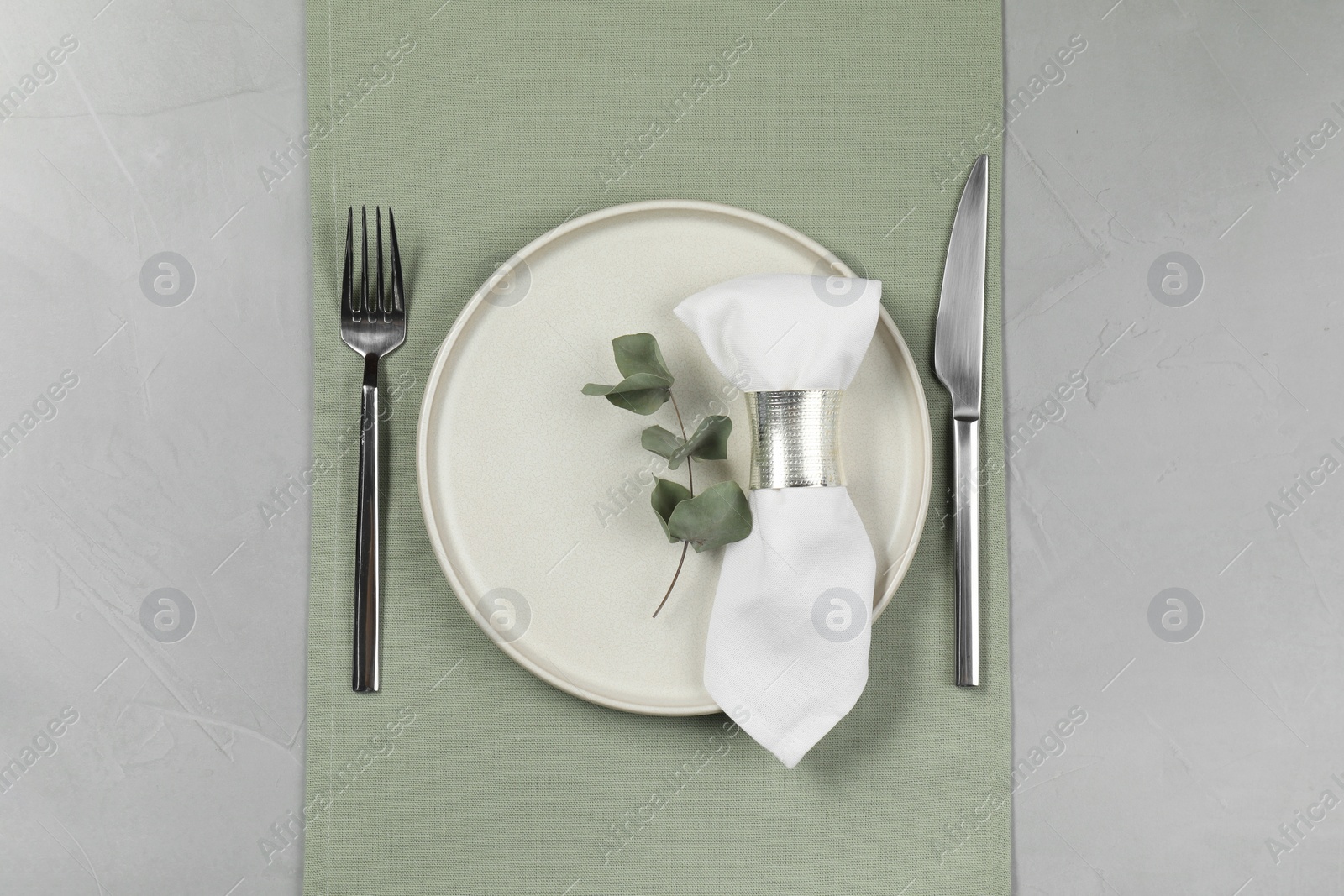 Photo of Stylish setting with elegant cutlery on grey table, top view