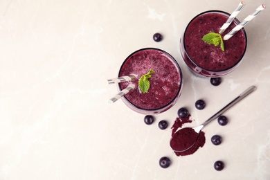 Glasses with delicious acai smoothie on table, top view