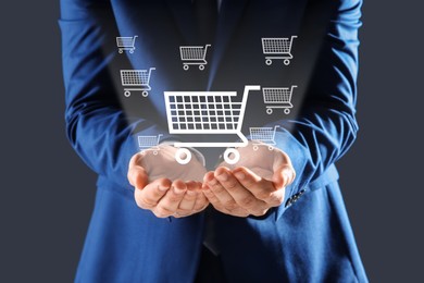Image of Man demonstrating virtual image of shopping cart on grey background, closeup