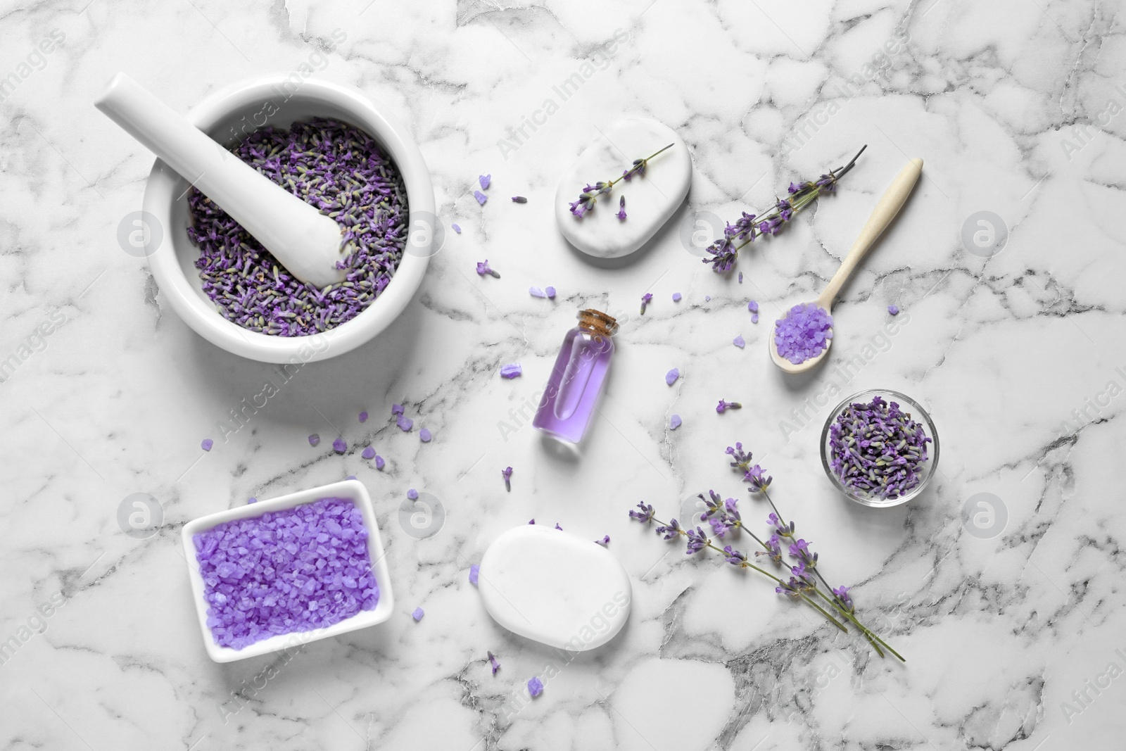 Photo of Flat lay composition with lavender flowers and natural cosmetic products on marble background