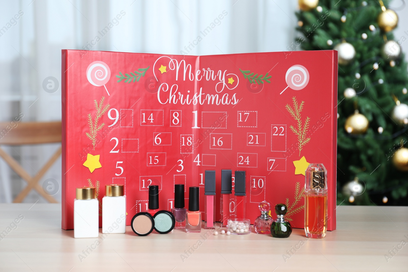 Christmas advent calendar with perfumes, skin care and decorative cosmetics on table Photo of Christmas advent calendar with perfumes, skin care and decorative cosmetics on table