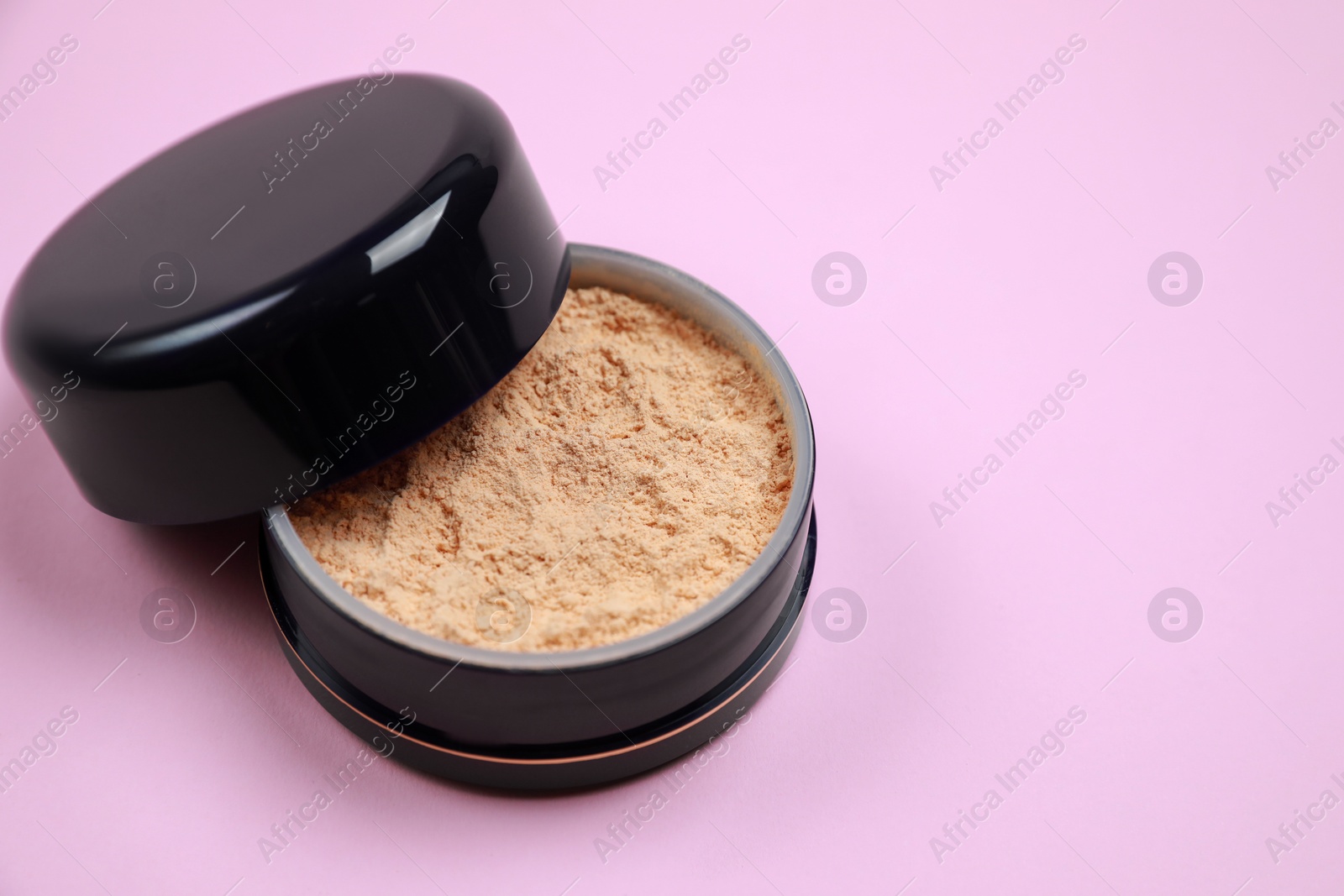 Photo of One face powder on pink background, space for text