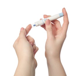 Diabetes. glucose testing. Woman using lancet pen on white background, closeup