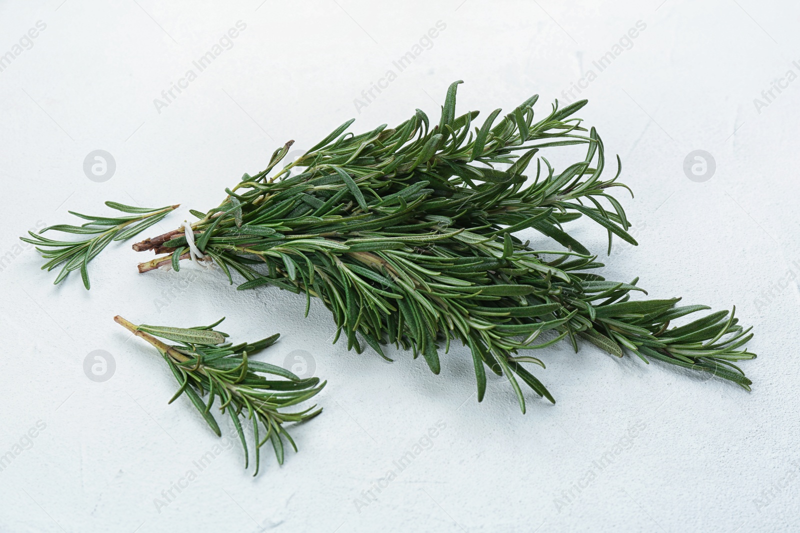 Photo of Bunch of fresh rosemary on white table