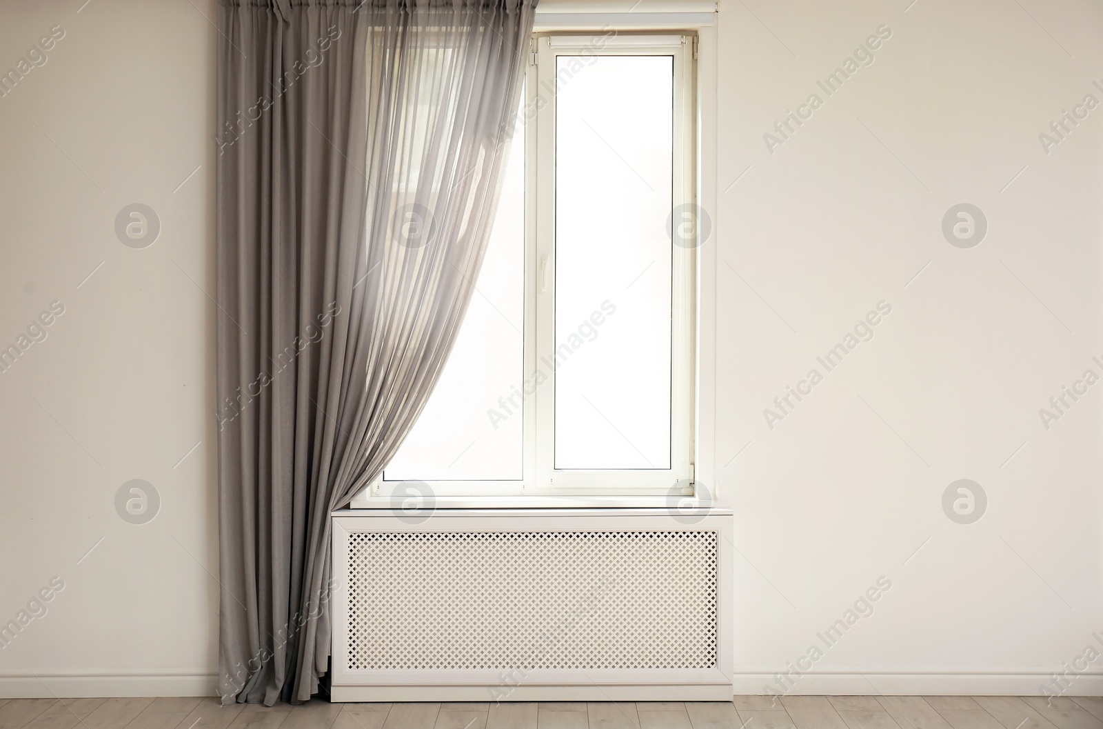 Photo of Light room with window and open curtains. Home interior