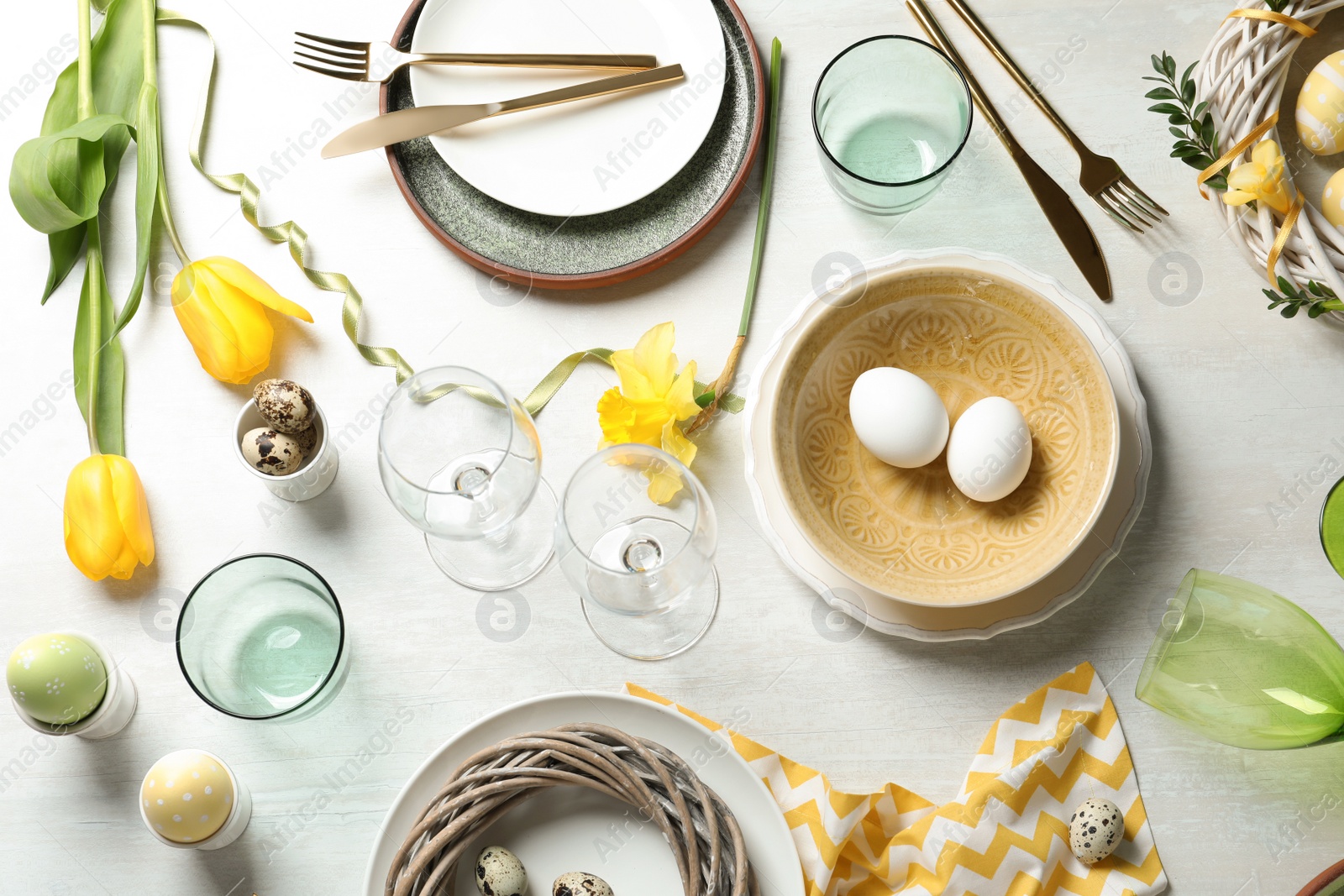 Photo of Festive Easter table setting with eggs on wooden background, top view