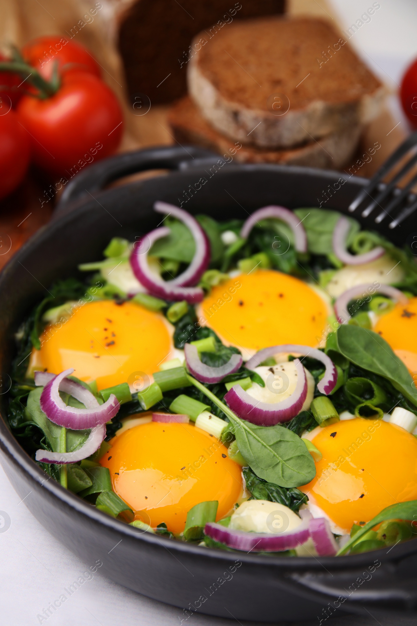 Photo of Tasty Shakshouka served on white table, closeup