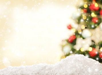 Image of Snow and blurred view of beautiful decorated Christmas tree. Bokeh effect