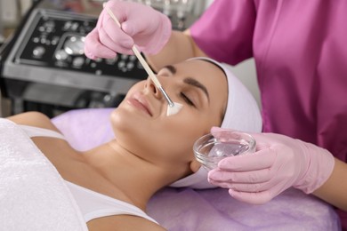 Young woman undergoing cosmetic procedure in beauty salon