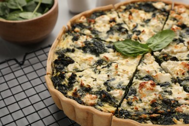 Delicious homemade spinach quiche on table, closeup