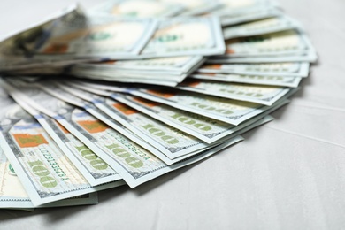 Photo of Many dollar banknotes on table, closeup view