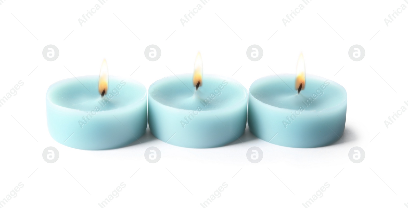 Photo of Light blue wax decorative candles isolated on white