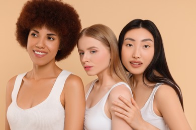 Photo of Portrait of beautiful young women on beige background