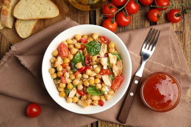 Photo of Delicious fresh chickpea salad served on wooden table